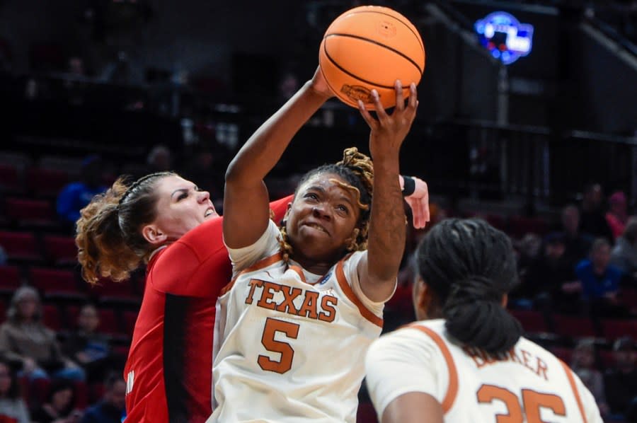 Texas forward DeYona Gaston (5) grabs a rebound during the first half of the team’s Elite Eight college basketball game against North Carolina State in the women’s NCAA Tournament, Sunday, March 31, 2024, in Portland, Ore. (AP Photo/Steve Dykes)