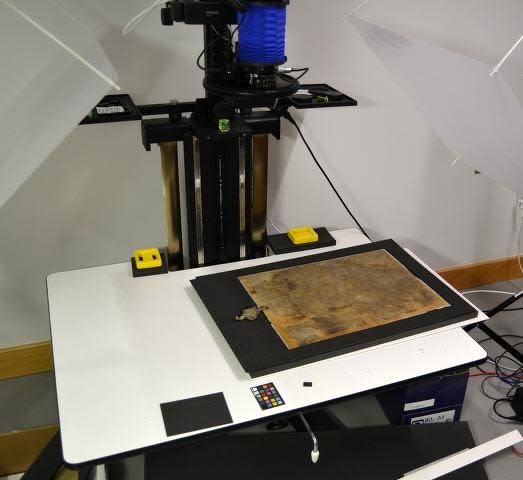 The "Burnt Magna Carta," damaged in a fire in 1215, is positioned for multispectral imaging.