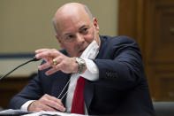 United States Postal Service Postmaster General Louis DeJoy speaks during a House Oversight and Reform Committee hearing on "Legislative Proposals to Put the Postal Service on Sustainable Financial Footing" on Capitol Hill, Wednesday, Feb. 24, 2021, in Washington. United States Postal Service Postmaster General Louis DeJoy is left. (Jim Watson/Pool via AP)