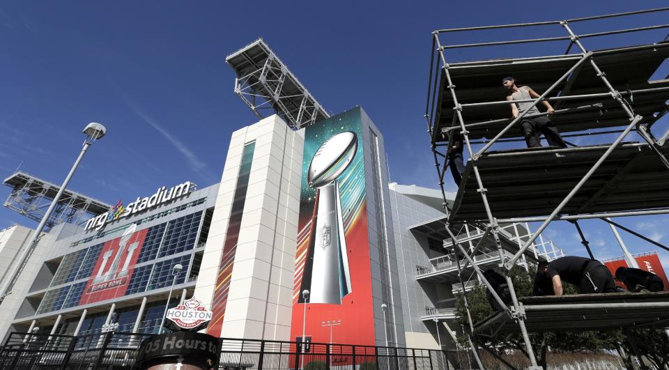 Workers prepare a lighting tower outside NRG Stadium, Tuesday, Jan. 24, 2017, in Houston. The New England Patriots will play the Atlanta Falcons in NFL football's Super Bowl LI on Sunday, Feb. 5, 2017, at NRG Stadium. (AP Photo/David J. Phillip)