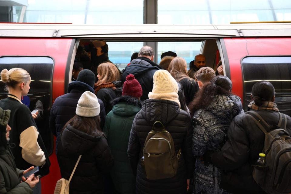 Commuters board an extremely delayed Central Line train (AFP via Getty Images)