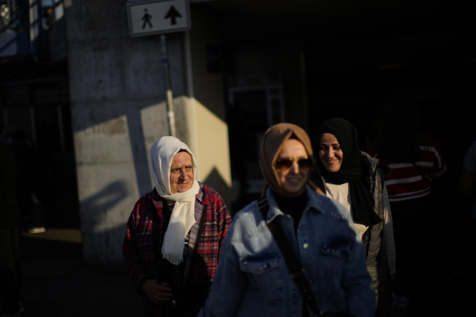 Pedestrians walk next to Galata bridge in Istanbul, Turkey, Friday, Oct. 28, 2022. Turkish President Recep Tayyip Erdogan on Friday laid out his vision for Turkey in the next century, promising a new constitution that would guarantee the rights and freedoms of citizens. (AP Photo/Francisco Seco)