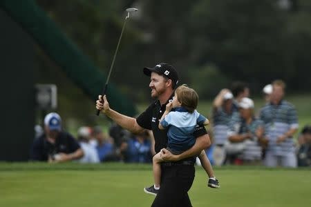 Jul 31, 2016; Springfield, NJ, USA; Jimmy Walker celebrates with his family on the 18th green after winning the tournament during the Sunday round of the 2016 PGA Championship golf tournament at Baltusrol GC - Lower Course. Eric Sucar-USA TODAY Sports