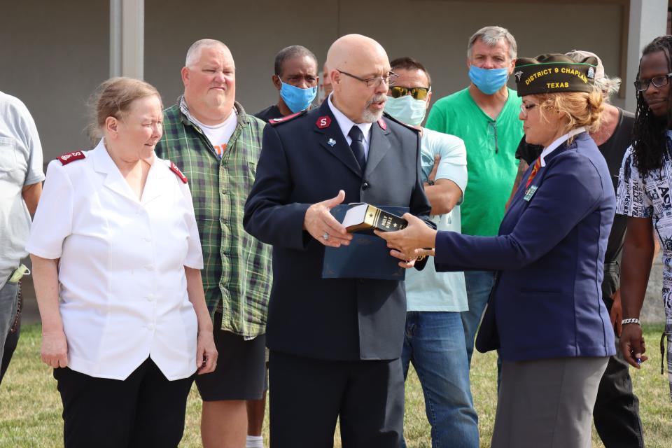 Brenna Barrett, right, District 9 Chaplin for VFW 1475, presents Majors Debra and Ernest Hull with a Bible for two years of leadership with the Salvation Army Harrington Hope Center as they end their service in the Texas Panhandle.