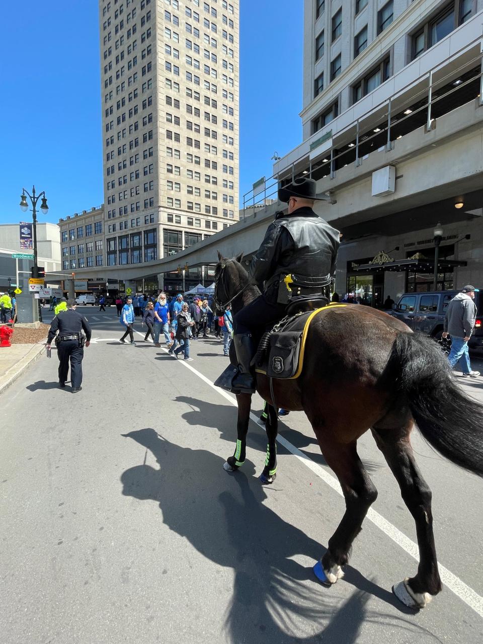 Wayne County Sheriff's Office Deputy Michael Dennis rides Ace in Detroit during the NFL draft on April 25, 2024.