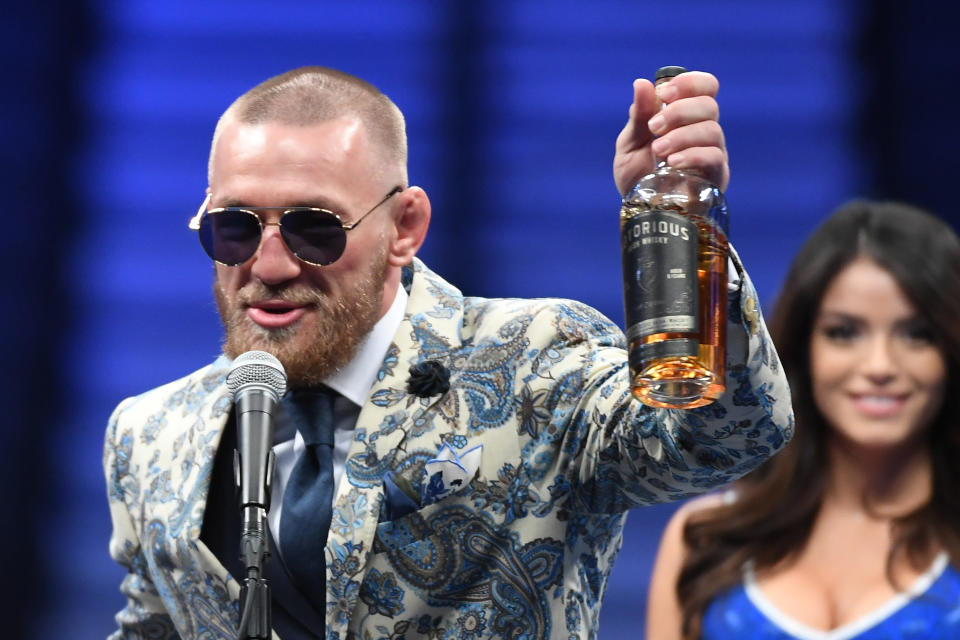 Conor McGregor speaks during a news conference while holding up his Notorious-branded Irish whiskey after his loss to Floyd Mayweather Jr. by 10th-round TKO in their super welterweight boxing match on August 26, 2017 at T-Mobile Arena in Las Vegas, Nevada. 