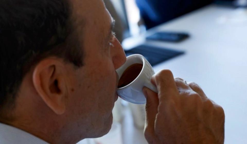 man drinking cup of espresso without coffee maker cleaner