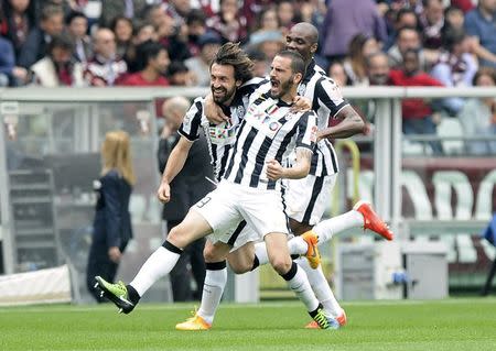 Juventus' Andrea Pirlo (L) celebrates with his team mates Leonardo Bonucci (C) and Angelo Ogbonna after scoring against Torino during their Italian Serie A soccer match at Olympic Stadium in Turin April 26, 2015. REUTERS/Giorgio Perottino