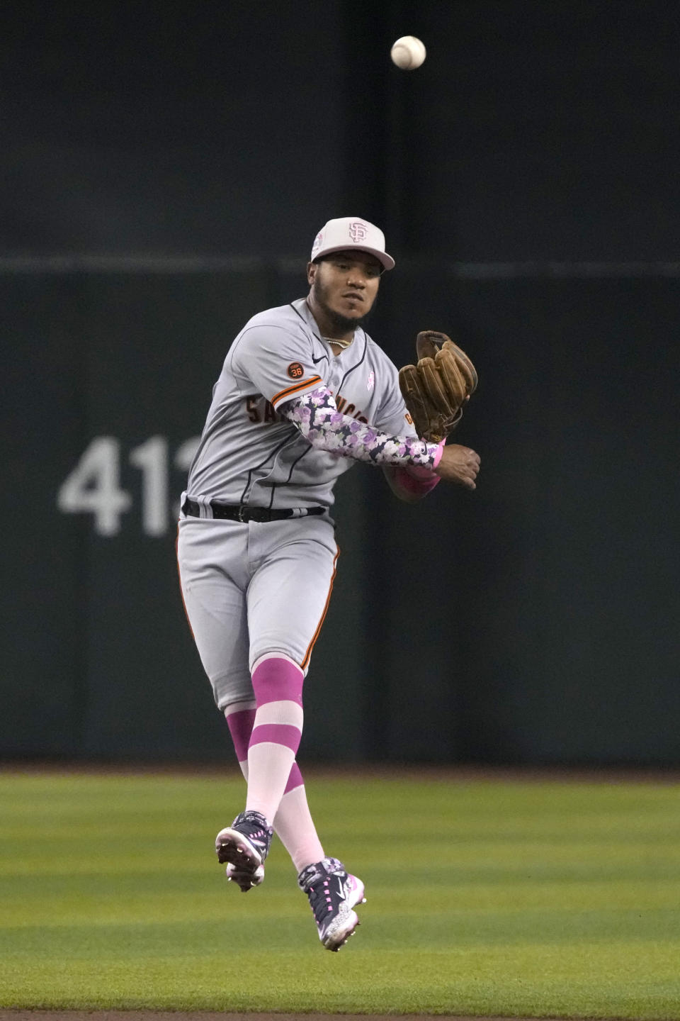 San Francisco Giants second baseman Thairo Estrada makes an off-balance throw for an out on a ball hit by Arizona Diamondbacks' Josh Rojas in the first inning during a baseball game, Sunday, May 14, 2023, in Phoenix. (AP Photo/Rick Scuteri)