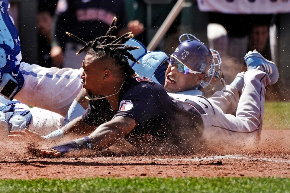 Cleveland Guardians' Jose Ramirez, front, beats the tag by Kansas City Royals catcher Salvador Perez to steal home June 29 in Kansas City, Mo.