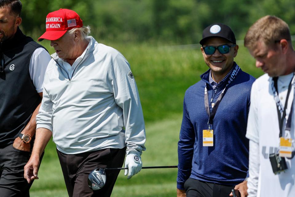 Walt Nauta, personal aide to former US President Trump, walks with him at the Trump National Golf Club in Sterling, Virginia (Reuters)