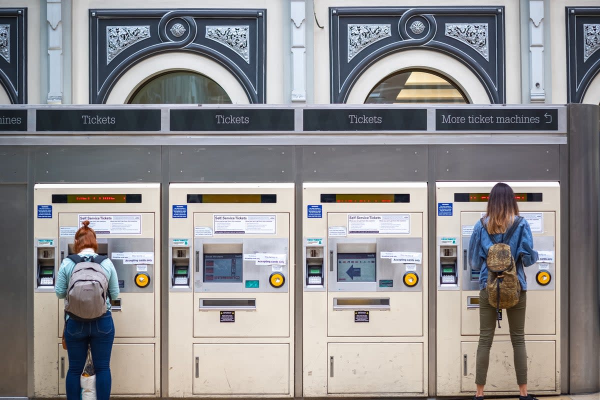 Passengers purchasing train tickets from machines at London Paddington station (Getty Images)