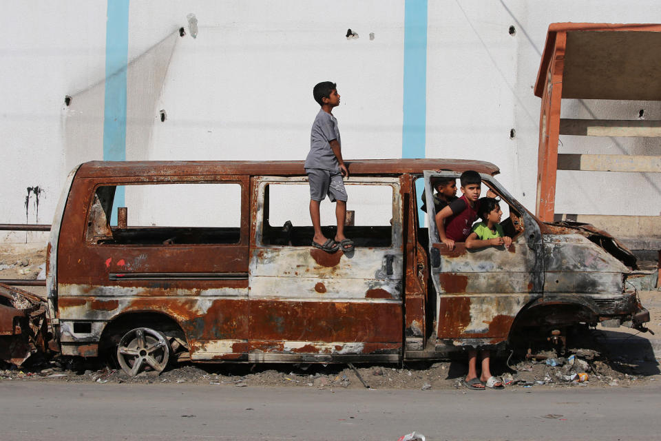 Palestinian children play in the remains of a charred vehicle in Rafah (AFP - Getty Images)
