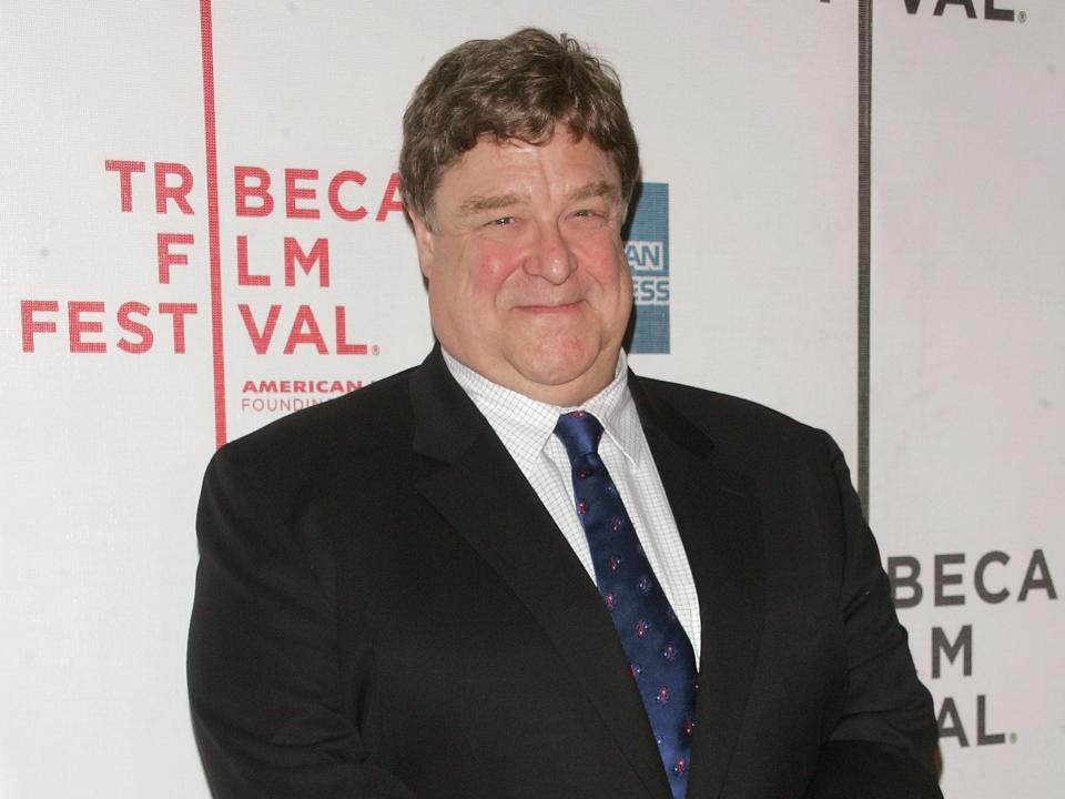 John Goodman wearing a black suit with a blue tie at the 7th Annual Tribeca Film Festival Speed Racer premiere
