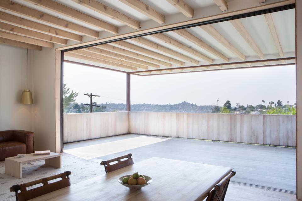 AFTER: The Douglas fir deck, which has a roof, adds indoor-outdoor living to the home. It also cools the rest of the property when the doors are fully open. Grey salvaged all the doors and windows from the ReUse People. “It was a great place where you could find the things multimillion-dollar renovations weren’t interested in, for whatever reason, at a big discount,” she says.