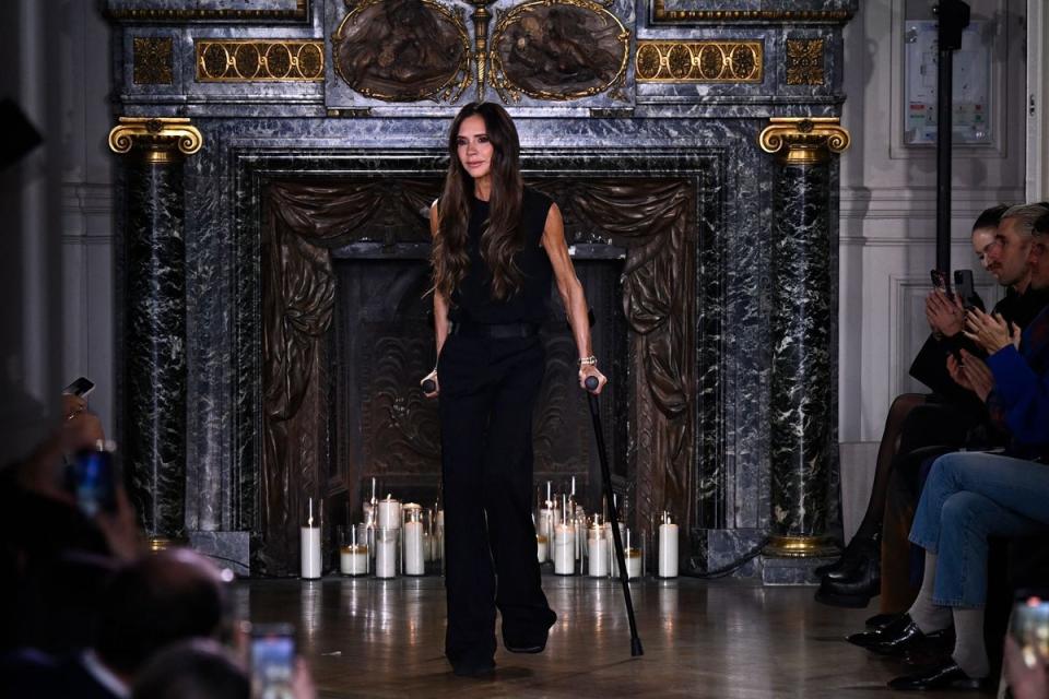 Victoria Beckham takes to the catwalk on crutches after presenting her autumn / winter 2024/2025 collection as part of the Paris Fashion Week (AFP via Getty Images)
