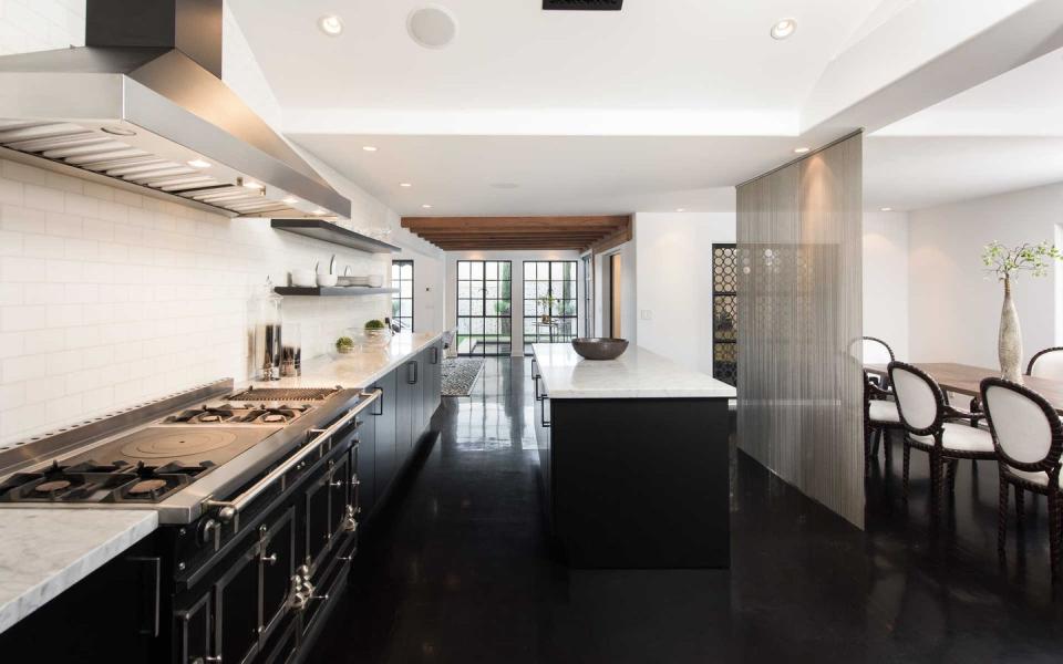 <p>The white kitchen is a chef's dream: classic subway tile and Calacatta marble at as backdrop to a professional-grade stove from celebrity favorite La Cornue. </p>