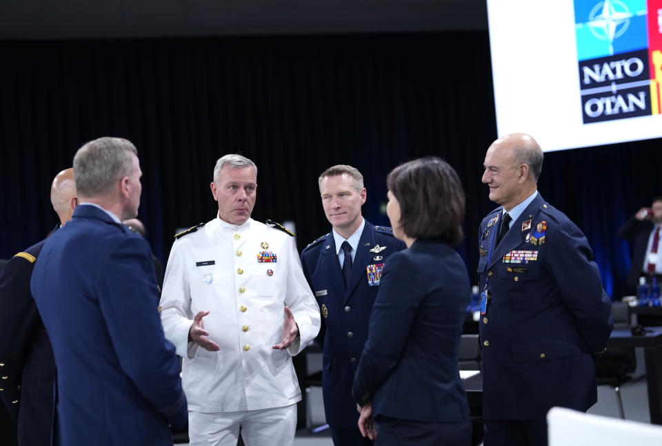 NATO's Chair of the Military Committee, Admiral Rob Bauer, center left, speaks with German Foreign Minister Annalena Baerbock, center right, during a round table meeting at a NATO summit in Madrid, Spain on Thursday, June 30, 2022. North Atlantic Treaty Organization heads of state will meet for the final day of a NATO summit in Madrid on Thursday. (AP Photo/Bernat Armangue)