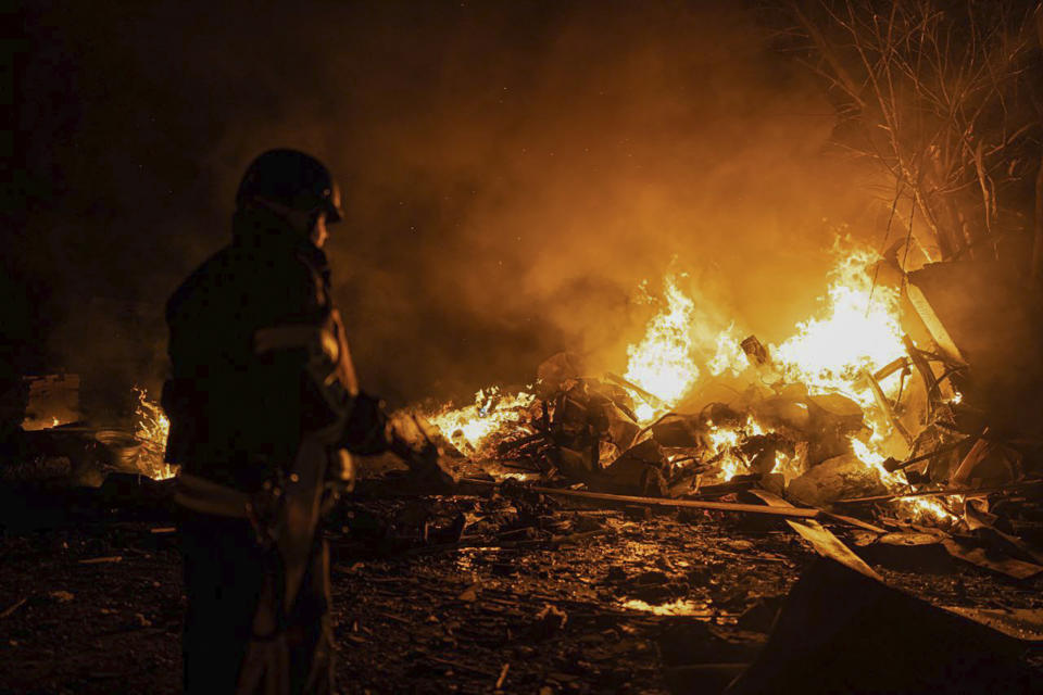 In this photo provided by the Ukrainian Emergency Situations Ministry, firefighters put out fire caused by fragments of a Russian rocket after it was shot down by air defense system during the night Russian rocket attack in Kyiv, Ukraine, early Tuesday, May 16, 2023. (Ukrainian Emergency Situations Ministry via AP)