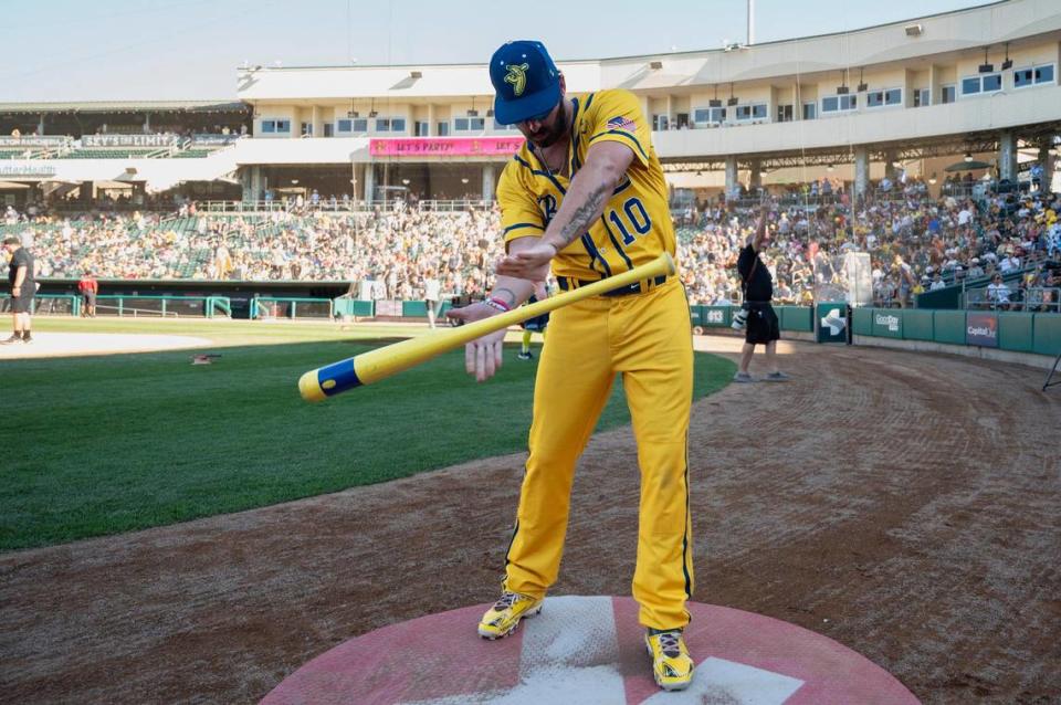 Savanna Bananas’ Alex Ziegler (10) performs bat tricks during the Savannah Bananas World Tour on Saturday, July 29, 2023, at Sutter Health Park in West Sacramento. Ziegler holds two Guinness World Records and two unwritten records.