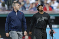 Cleveland Indians' Jose Ramirez, right, walks off the field with a trainer during the first inning of the team's baseball game against the Kansas City Royals, Saturday, Aug. 24, 2019, in Cleveland. (AP Photo/Tony Dejak)