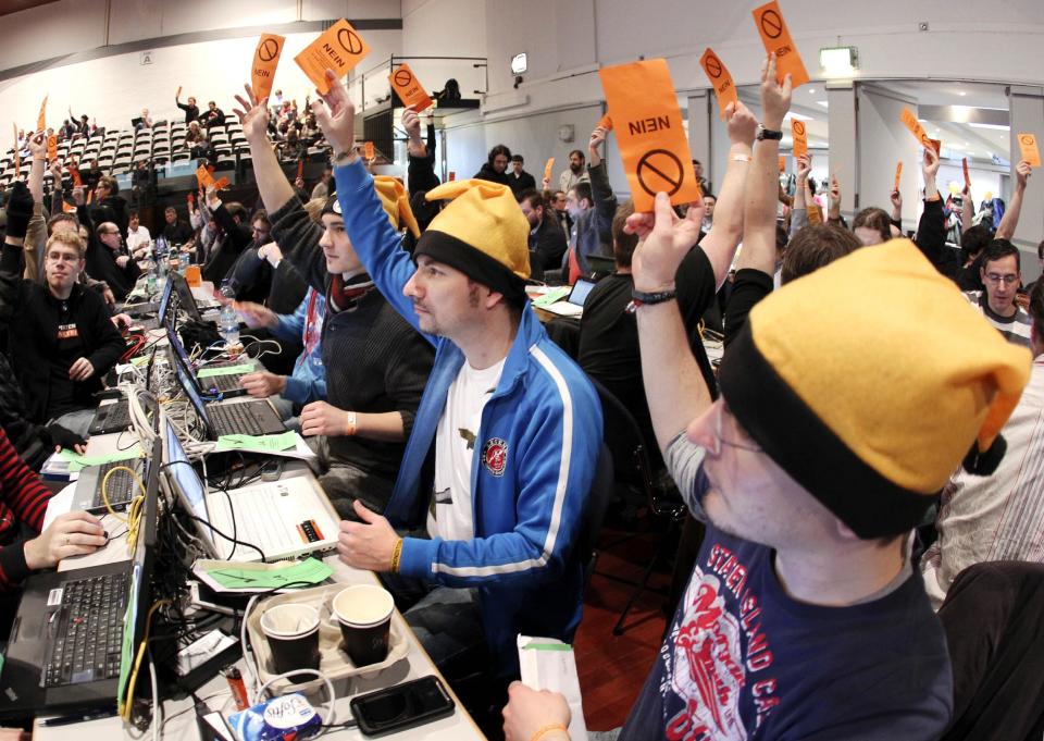 FILE - The Dec. 4, 2011 file photo shows party members casting their vote during a party meeting of the German Pirate Party in Offenbach, Germany. A new poll published Tuesday, April 3, 2012 shows support for Germany's upstart Pirate Party rising to a record 12 percent after its second success in a state election — underlining its arrival as a force in national politics. The Pirates, with a platform based on near-total transparency and Internet freedom, first won seats in a state legislature in Berlin last September. On March 25 they won seats in Saarland, in western Germany (AP Photo/Michael Probst, file)