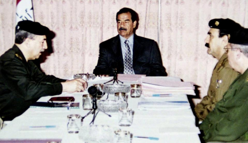 Saddam Hussein meets with military officials in Baghdad on 16 April 2002 (INA/AFP/Getty)