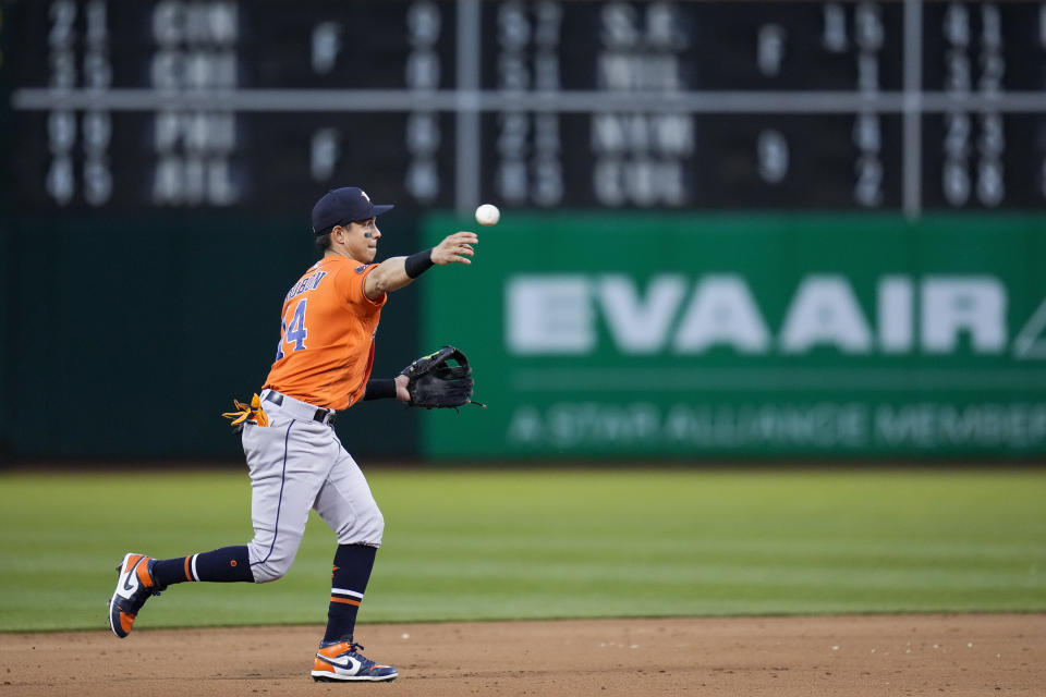 Houston Astros shortstop Mauricio Dubón throws to first for an out against Oakland Athletics' Aledmys Díaz during the fifth inning of a baseball game in Oakland, Calif., Friday, May 26, 2023. (AP Photo/Godofredo A. Vásquez)