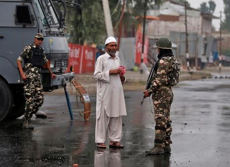 A man shows medicine to a policeman after he was stopped by the police during a curfew in Srinagar July 15, 2016. REUTERS/Danish Ismail