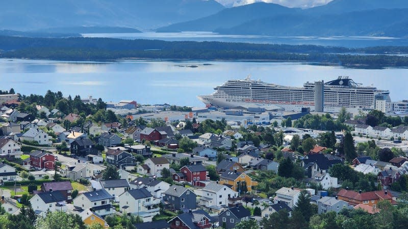 Overlooking a seaside village with a cruise ship in the background