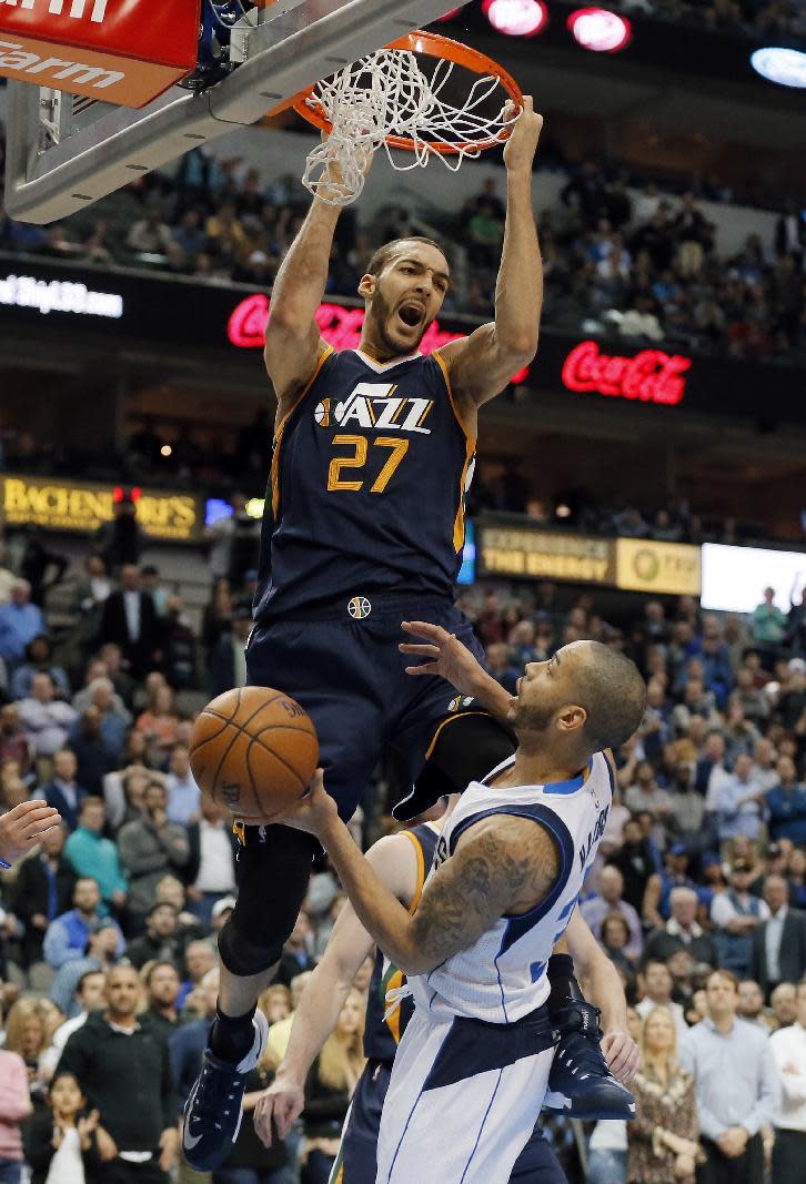 FILE - In this Thursday, Feb. 9, 2017, file photo, Utah Jazz center Rudy Gobert (27) of France dunks over Dallas Mavericks' Devin Harris (34) late in the second half of an NBA basketball game in Dallas. Boris Diaw and Gobert, both veterans, said having a teammate from their native country can help young players focus on just basketball. “Just speaking French, makes me feel better," Gobert said. "It’s a stupid thing, but I needed a French player on the team.” (AP Photo/Tony Gutierrez, File)