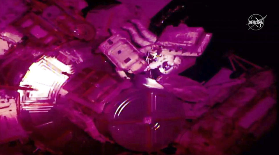 In this image taken from NASA video Italian astronaut Luca Parmitano and U.S. astronaut Andrew Morgan work to install new pumps on a cosmic ray detector outside the International Space Station, Monday, Dec. 2, 2019. Monday’s spacewalk is the third in nearly three weeks for the pair and is the culmination of years of work to repair the Alpha Magnetic Spectrometer. (NASA via AP)