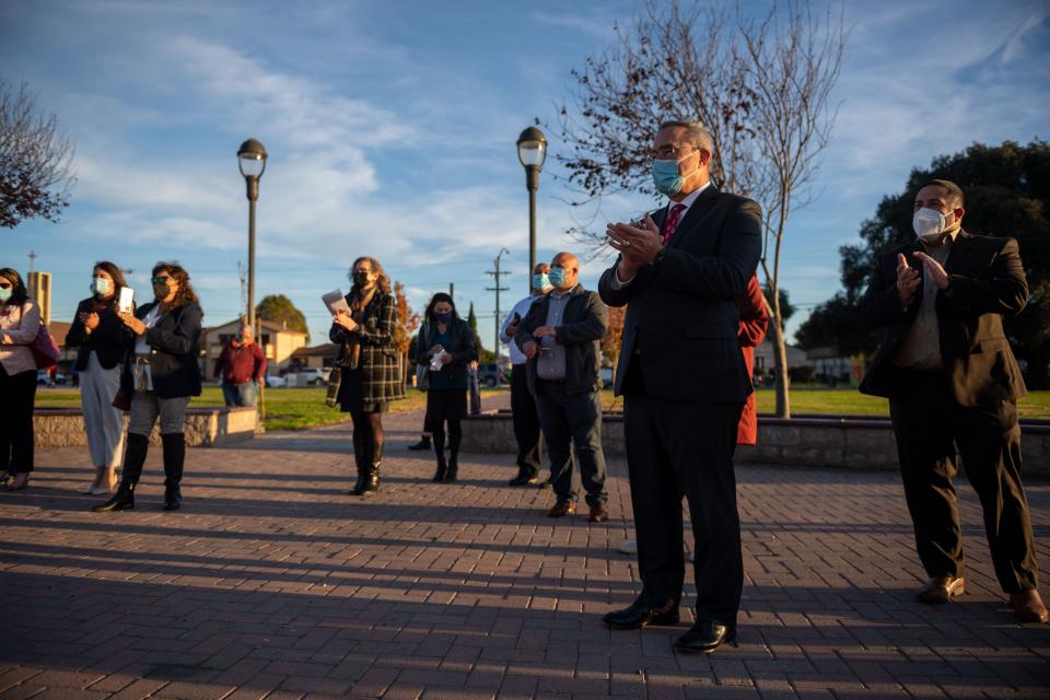 Alisal Union School District Superintendent, Kim Koenig, left, and Salinas Union High School Superintendent, Dan Burns, clap alongside other community leaders as Rep. Jimmy Panetta (D-Carmel Valley) talks about the bipartisan Infrastructure Investment and Jobs Act at Closter Park in Salinas, Calif., on Wednesday, Jan. 5, 2022.