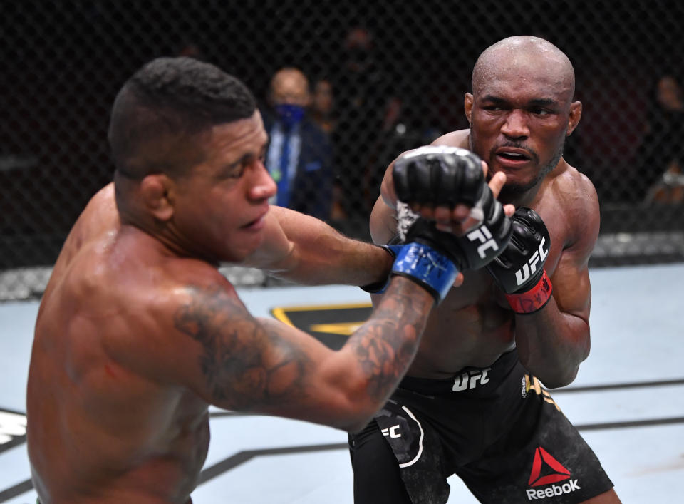 LAS VEGAS, NEVADA - FEBRUARY 13: In this handout image provided by UFC, (R-L) Kamaru Usman of Nigeria punches Gilbert Burns of Brazil in their UFC welterweight championship fight during the UFC 258 event at UFC APEX on February 13, 2021 in Las Vegas, Nevada. (Photo by Jeff Bottari/Zuffa LLC via Getty Images)