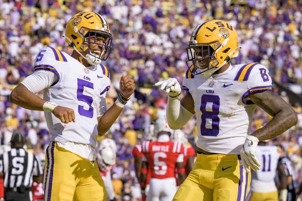 FILE - LSU quarterback Jayden Daniels (5) celebrates a touchdown with wide receiver Malik Nabers (8) during the first half of an NCAA college football game against Mississippi in Baton Rouge, La., Saturday, Oct. 22, 2022. LSU opens their season at Florida State on Sept. 3. (AP Photo/Matthew Hinton, File)