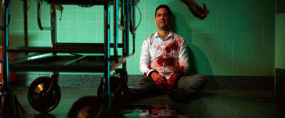 A traumatized, blood-covered man collapses on a hospital floor after a surgery gone wrong in "Southbound"