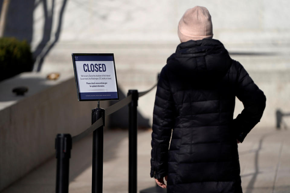 A woman looks at a sign declaring the National Archive closed due to a partial federal government shutdown in Washington, D.C., Dec. 22, 2018. (Photo: /Joshua Roberts/Reuters)