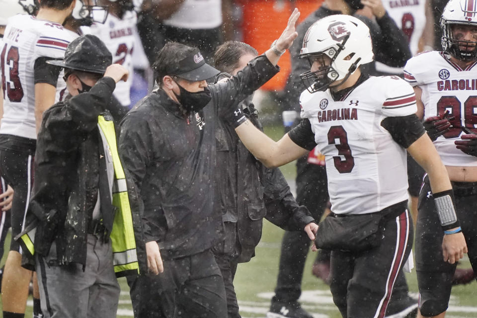 South Carolina head coach Will Muschamp celebrates with quarterback Ryan Hilinski (3) after South Carolina defeated Vanderbilt 41-7 in an NCAA college football game Saturday, Oct. 10, 2020, in Nashville, Tenn. (AP Photo/Mark Humphrey)