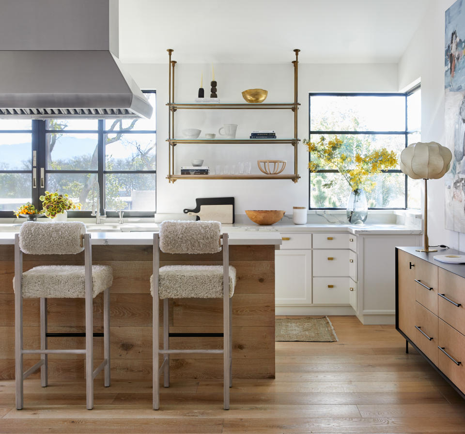 A kitchen with  a range hood above island