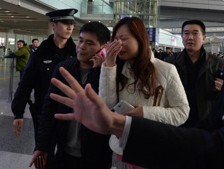 A possible relative cries at the Beijing Airport after news of the missing Malaysia Airlines Boeing 777-200 plane in Beijing on March 8, 2014
