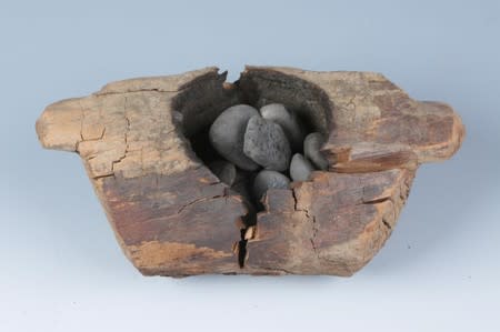 Wooden brazier and burnt stones from an archaeological site in western China