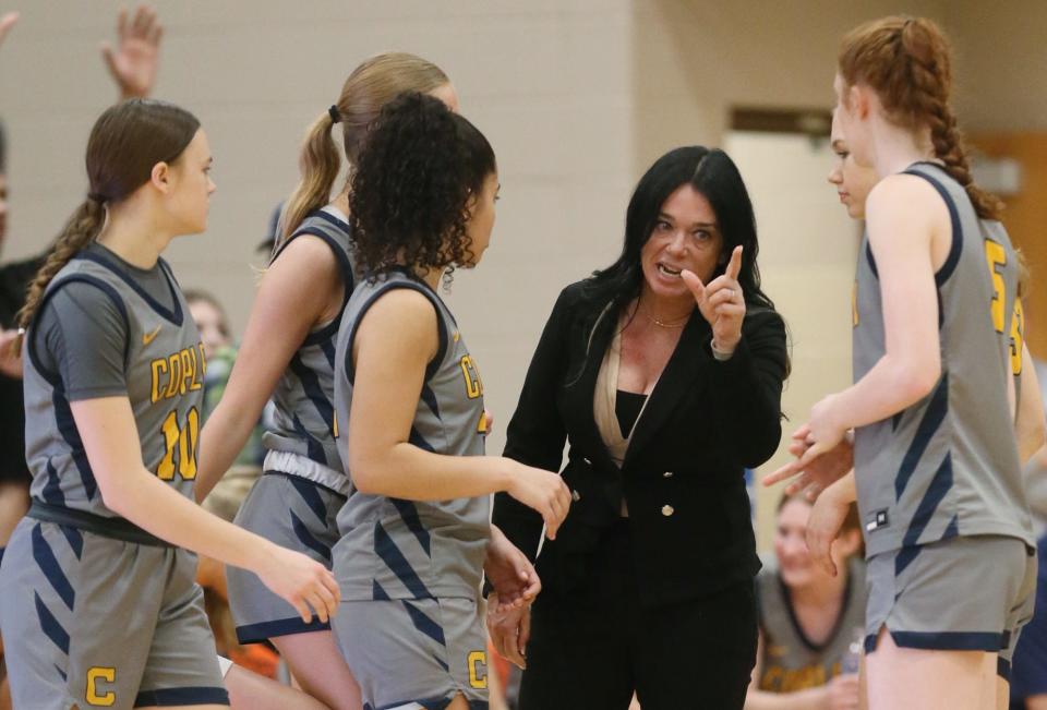 Copley head coach Julie Solis talks to her players between periods in the OHSAA Division II regional final against Bryan at Mansfield High School, March 8, 2024.