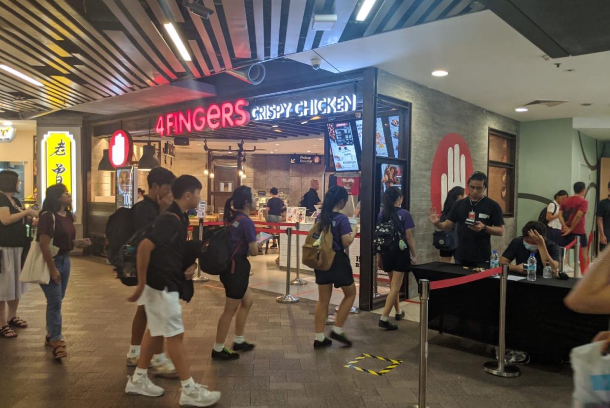 Patrons queueing to get into an area of Causeway Point on 27 March, 2020. (PHOTO: Yahoo News Singapore)