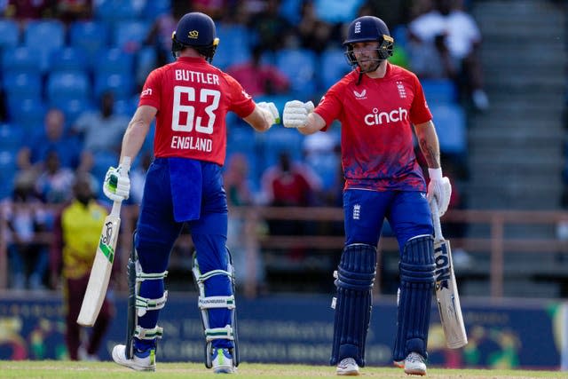 Phil Salt, centre, and Jos Buttler right, have put on successive century stands (Ricardo Mazalan/AP)