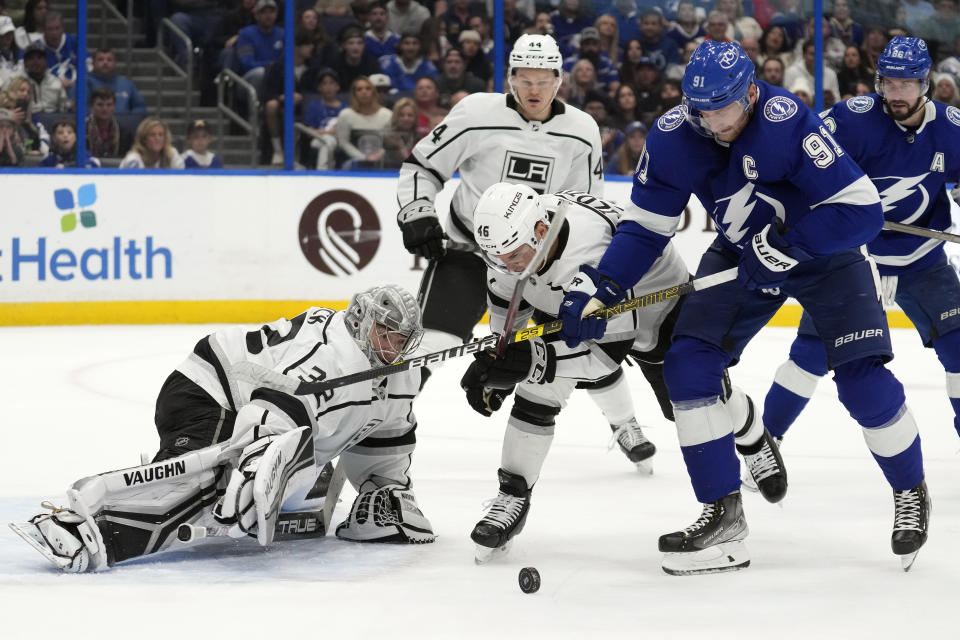 Tampa Bay Lightning center Steven Stamkos (91) battles with Los Angeles Kings center Blake Lizotte (46) after goaltender Jonathan Quick (32) made a save during the second period of an NHL hockey game Saturday, Jan. 28, 2023, in Tampa, Fla. (AP Photo/Chris O'Meara)