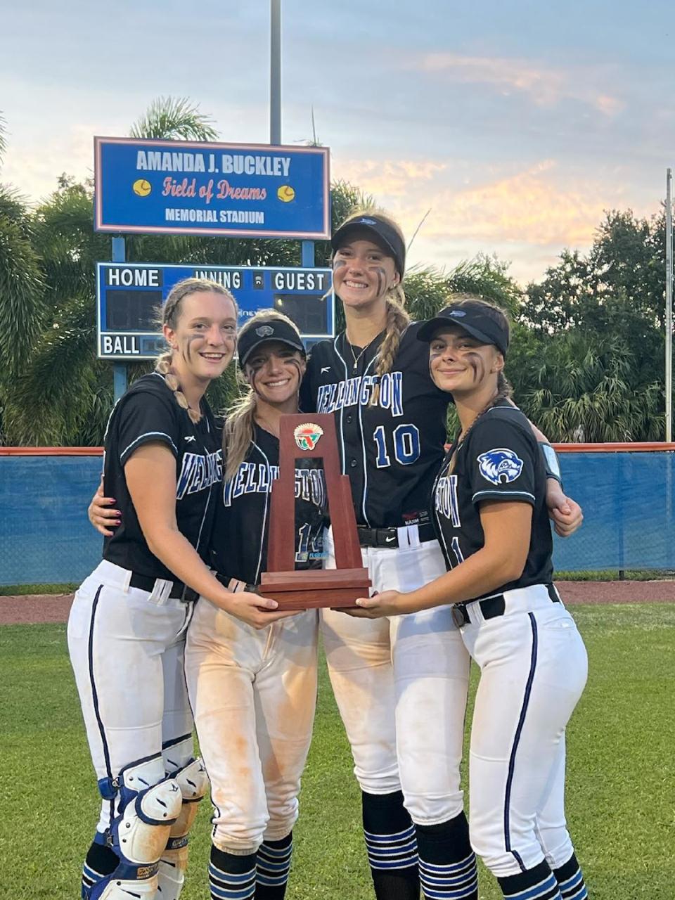 From left to right: Wellington's Kaylee Riles, Kaitlyn Campbell, Jordan White and Kylie McCan celebrate the Wolverines' district championship win over Jupiter on May 4, 2023.