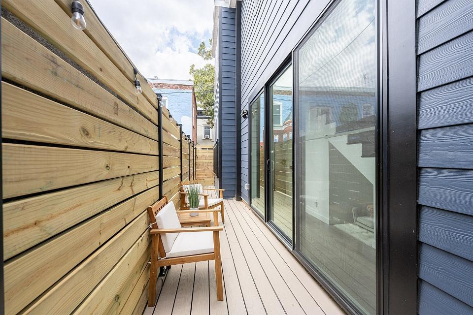 The narrow outdoor patio of a skinny home.