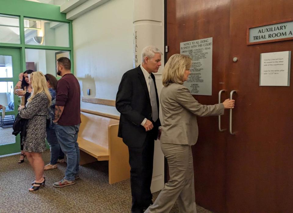 Supporters of 2-year-old Jason Wilder McDaniel talk to the left as Wichita County District Attorney John Gillespie, second to the right, and Special Prosecutor Lisa Tanner, far right, enter a courtroom in the Tim Curry Criminal Justice Center during James Staley Irven III's murder trial on Thursday, March 2, 2023, in downtown Fort Worth.