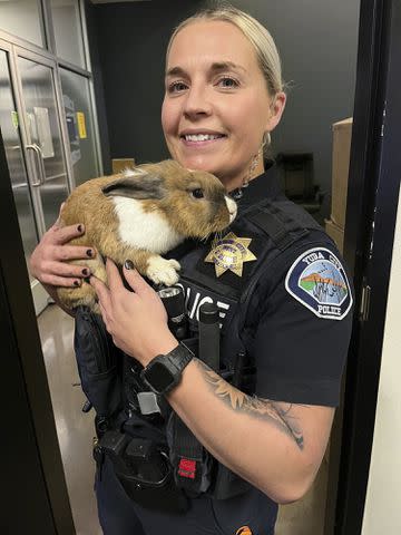 Courtesy of Yuba City Police Department Officer Ashley Carson holds Percy on the night he was found