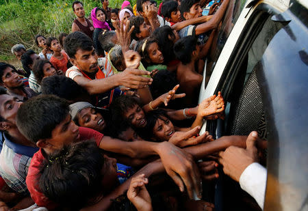 Rohingya refugees stretch their hands for food near Balukhali in Cox’s Bazar, Bangladesh, September 4, 2017. REUTERS/Mohammad Ponir Hossain